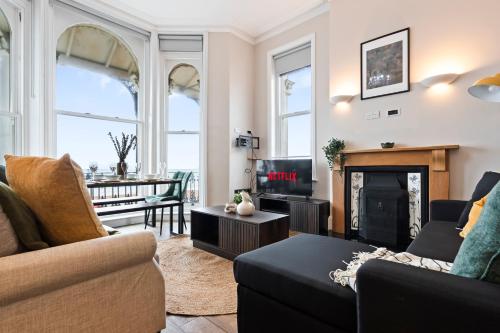 a living room with a couch and a fireplace at Modern 2 Bedroom Abode - Sea Views - Balcony in Worthing