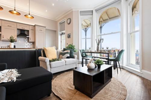 a living room with a couch and a table at Modern 2 Bedroom Abode - Sea Views - Balcony in Worthing