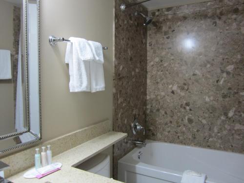 a bathroom with a tub and a toilet and a sink at Best Western Prince George Downtown in Prince George