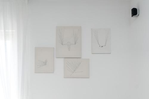 a group of drawings of a plant on a wall at Residenza Sant'Angelo - Art Apartment in Minori
