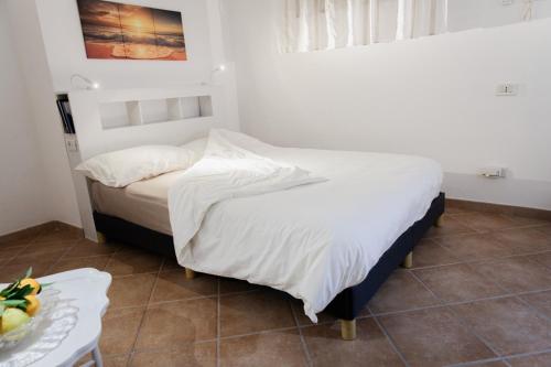 a bedroom with a bed and a table with a bowl of fruit at B&B Cico "Grazioso Monolocale" in Santa Marinella