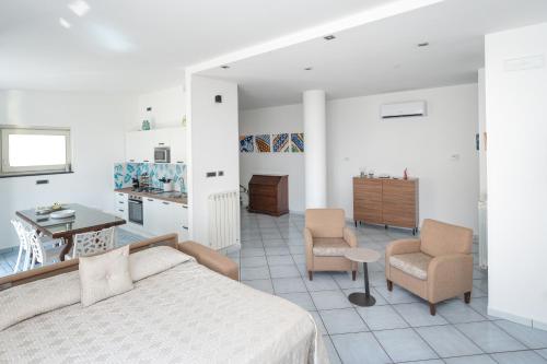 a bedroom with a bed and a table and chairs at Residenza Sant'Angelo - Art Apartment in Minori