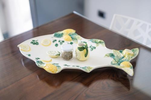 a plate on a table with jars on it at Residenza Sant'Angelo - Art Apartment in Minori