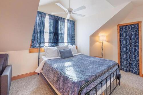 a bedroom with a bed with a ceiling fan and a window at Vitamin Beach 12 in Avon