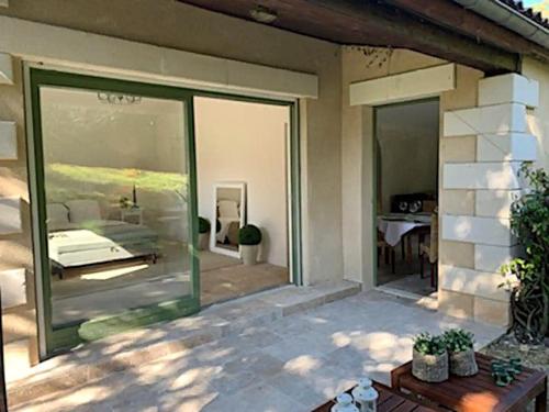 a patio with sliding glass doors leading to a bedroom at Domaine de Monciaux 2 piscines Tennis 40 Pers in Bourrou