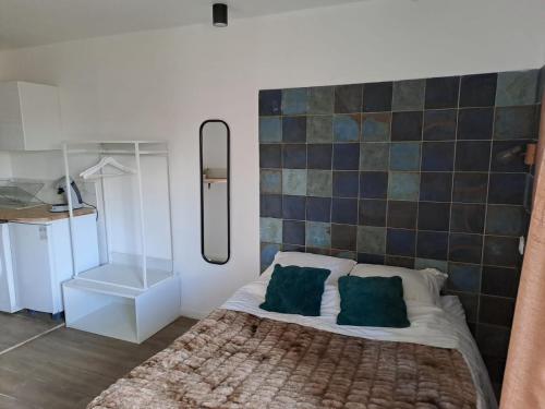 a bedroom with a bed with a tiled wall at Lafayette Gare Saint-Charles in Marseille