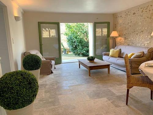a living room with a couch and a table at Domaine de Monciaux 2 piscines Tennis 40 Pers in Bourrou