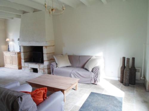 a living room with a couch and a coffee table at Domaine de Monciaux 2 piscines Tennis 40 Pers in Bourrou