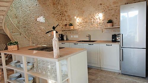 a kitchen with a refrigerator and a counter with a sink at Domaine de Monciaux 2 piscines Tennis 40 Pers in Bourrou