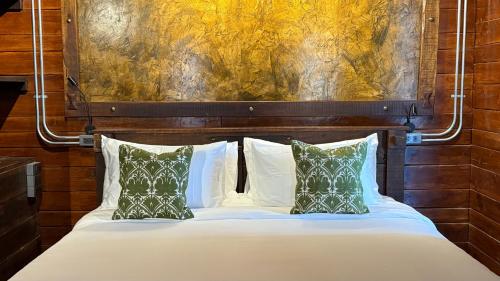 a bed with white sheets and pillows in a room at Kawarin River Exclusive Hotel & Resort in Ban Gaeng Cho