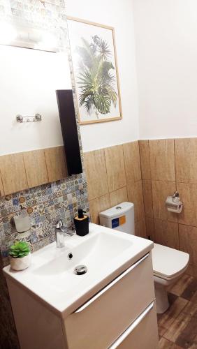 a bathroom with a sink and a toilet and a mirror at Casa Nicolae in Brăila