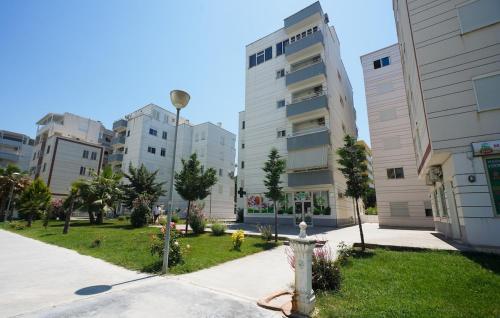 a fire hydrant in the middle of a park with buildings at Seaside Home in Golem
