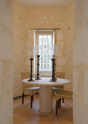 a table with two candles on it in a room at Domaine de Monciaux 2 piscines Tennis 40 Pers in Bourrou