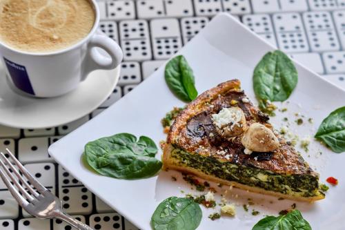 a plate with a sandwich and a cup of coffee at La Concha Key West, Autograph Collection in Key West
