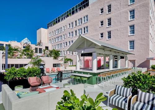 a patio with chairs and tables in front of a building at La Concha Key West, Autograph Collection in Key West