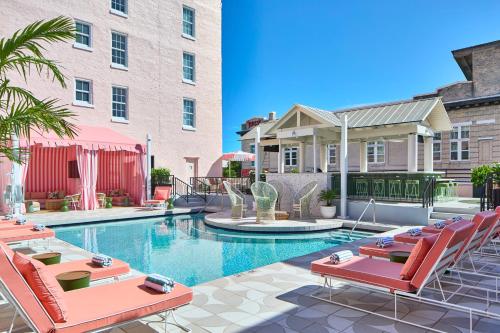 a swimming pool with lounge chairs and a building at La Concha Key West, Autograph Collection in Key West