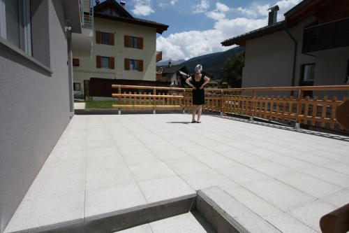 a woman standing on the roof of a building at Casa Ai Stabli 3 in Mezzana