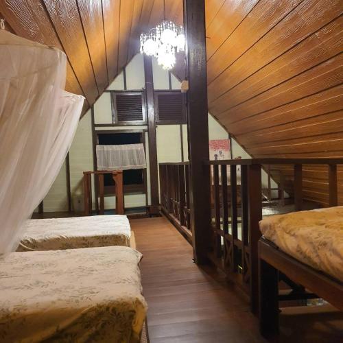 a bedroom with two beds and a chandelier at Sandy Lake 2012 in Kaeng Krachan