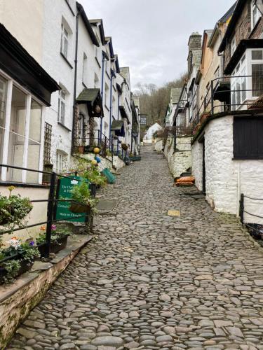 a cobblestone street in a town with buildings at Cosy north Devon lodge within Hartland forest in Exeter