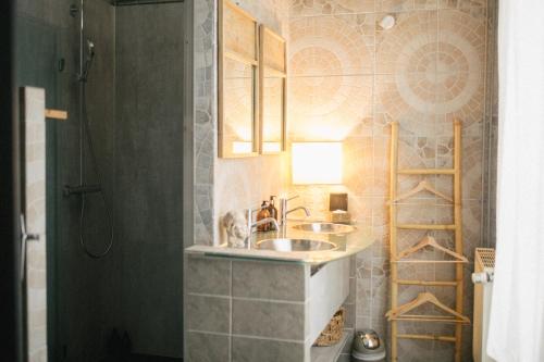 a bathroom with a sink and a shower at Le Petit Château de Conteville in Paluel