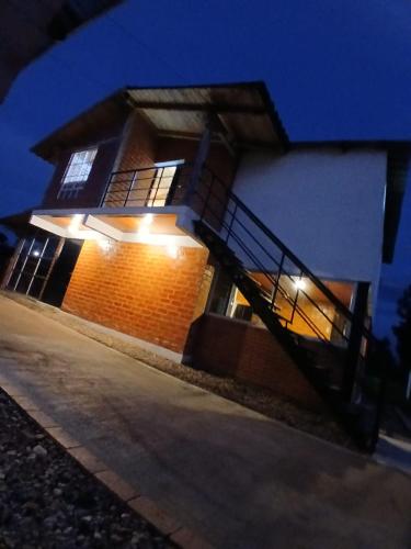 a house with a staircase in front of it at night at Finca Dulce María J&M Hospedaje Rural in Tunja