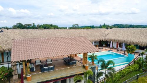 an overhead view of a house with a roof and a swimming pool at Hacienda San Nicolas -Pto Boyaca in Puerto Triunfo