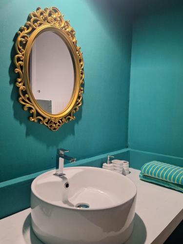 a bathroom with a white sink and a mirror at X Mirissa in Mirissa