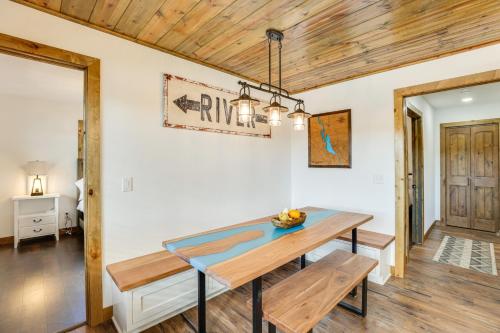 a dining room with a table and benches at Riverfront Home with Private Dock in Wisconsin Dells in Lyndon Station