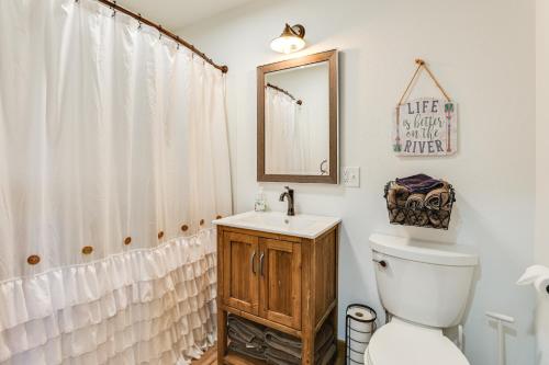 a bathroom with a toilet and a sink and a mirror at Riverfront Home with Private Dock in Wisconsin Dells in Lyndon Station