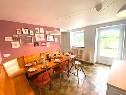 a dining room with a wooden table and chairs at La Ferme familiale de Percy - 9 pers in Percy-en-Auge