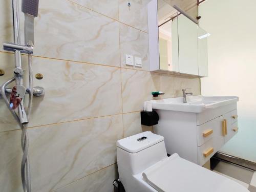 a bathroom with a toilet and a sink and a shower at 凨凪凮夙雪山观景酒店 in Baisha