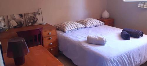 a bedroom with a large bed and a dresser at Villa Romance in Audenge