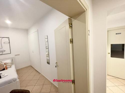 a room with a hallway with white walls at BARI ROOMS Abate Gimma in Bari