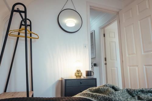a room with a bed and a mirror on the wall at 5 Bed Family Home- Free Parking in Woodham Ferrers Station