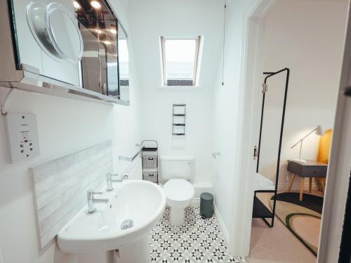a white bathroom with a sink and a toilet at 5 Bed Family Home- Free Parking in Woodham Ferrers Station