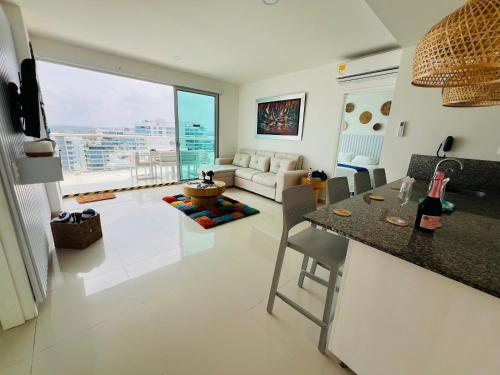 a kitchen and living room with a couch and a table at Cartagena in Cartagena de Indias