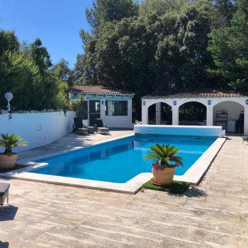 une piscine dans une cour avec une maison dans l'établissement villa spacieuse piscine jacuzzi 8 chambres 22 couchages, à Saint-Chamas