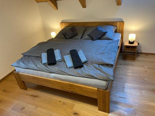 a bedroom with a bed with two pillows on it at Roubenka Vanedi in Olešnice v Orlických horách