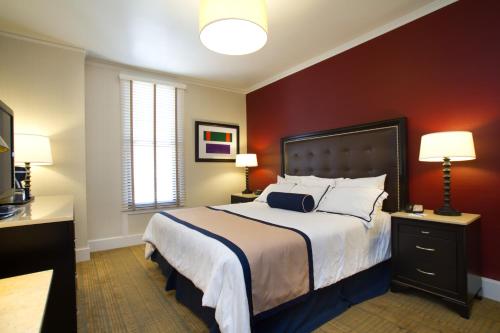 a bedroom with a large bed with red walls at Marines' Memorial Club & Hotel Union Square in San Francisco