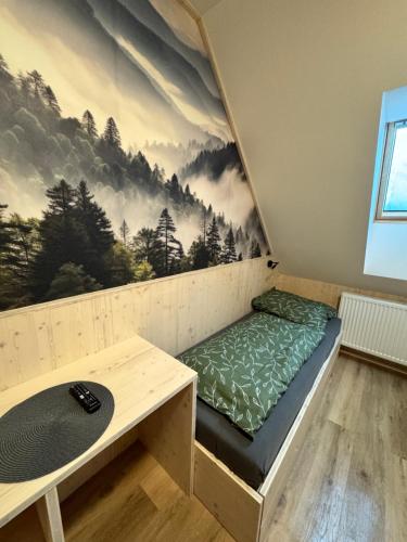 a room with a bed and a table at Penzion a Restaurace Pod Sjezdovkou in Čenkovice