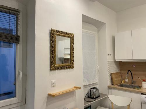 - une cuisine avec un miroir mural dans l'établissement Appt 2 chambres au centre ville 4è, à Marseille