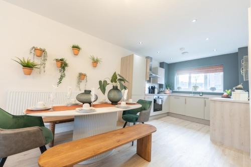 a kitchen and dining room with a table and chairs at The Show Home - Grange Meadows 7 Adults 2 Kids in Mossley