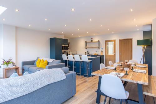 a living room with a blue couch and a table at Sunshine Cottage in Helmsley