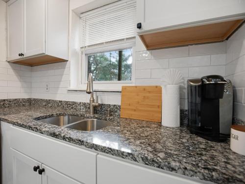 a kitchen counter with a sink and a window at Cozy Charming Unit In Takoma Park in Takoma Park