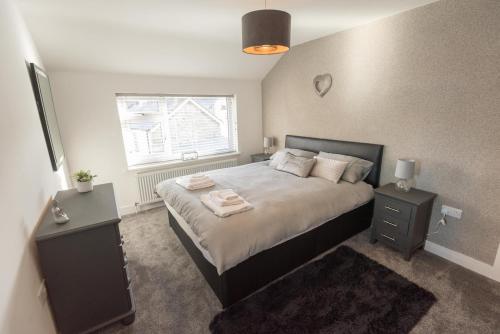 a bedroom with a large bed with two night stands at No 4 John Street in Bethesda