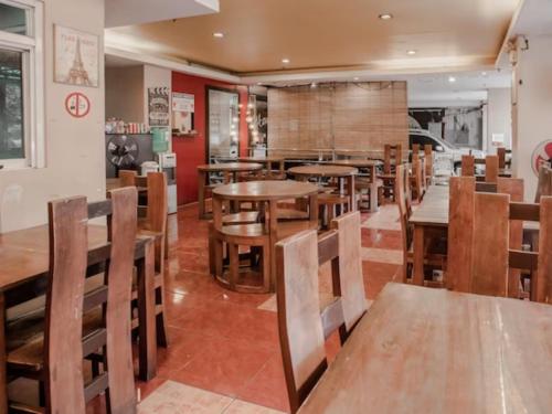 a dining room with wooden tables and chairs at Haeinsa Condotel in Manila