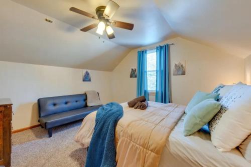 a bedroom with a bed with a ceiling fan and a couch at The Babbling Brooke in Blakeslee