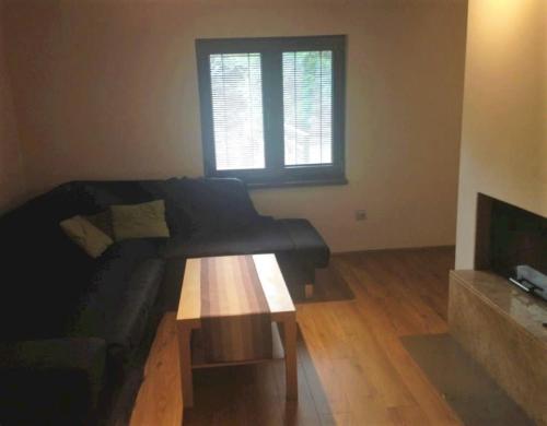 a living room with a couch and a coffee table at Chata Maruska in Ružomberok