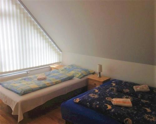 a bedroom with a bed and a window at Chata Maruska in Ružomberok