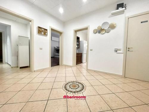 a hallway with white walls and a tile floor at BARI ROOMS Abate Gimma in Bari